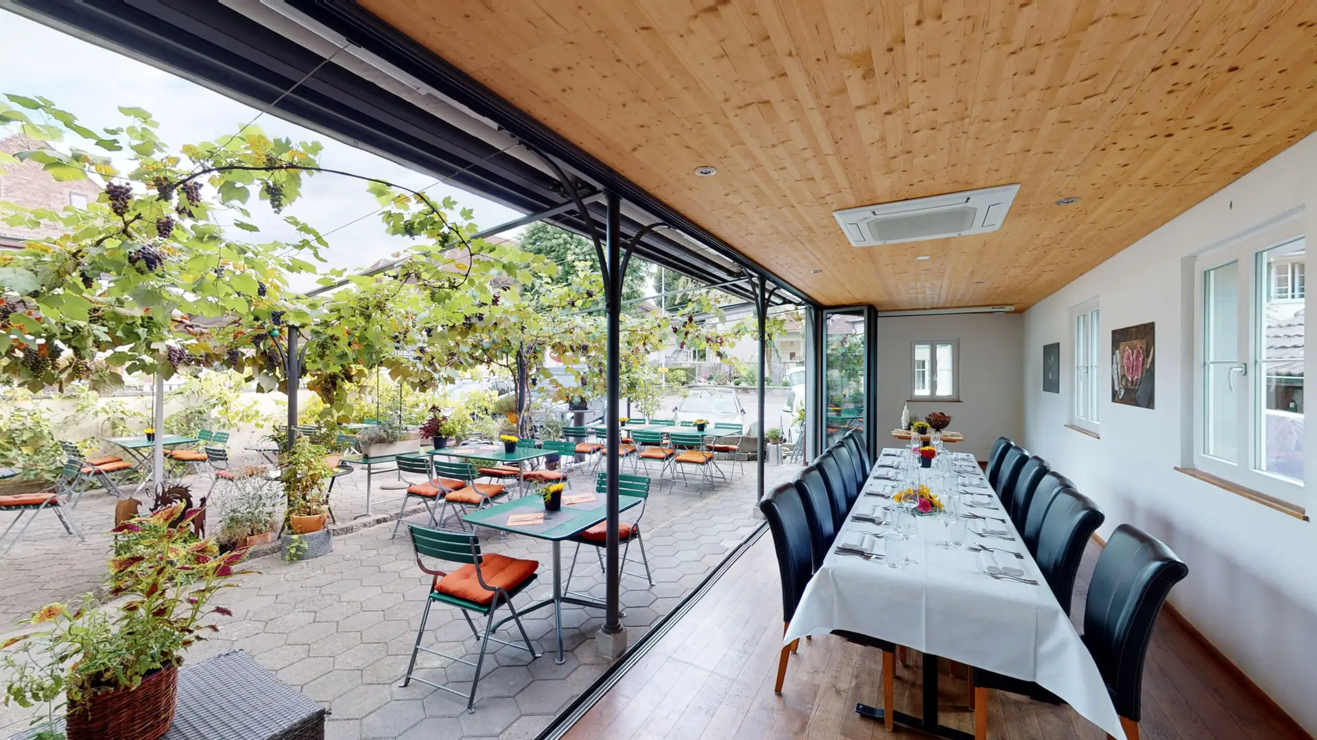 Wintergarten des Restaurant Stadtgarten Wangen an der Aare mit langer festlich gedeckter Tafel